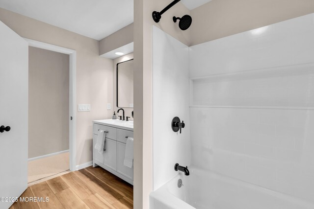 2627 Ramshorn Dr, Manasquan, NJ 08736 - bathroom featuring washtub / shower combination, wood finished floors, and vanity