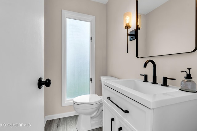 2627 Ramshorn Dr, Manasquan, NJ 08736 - half bath with vanity, healthy amount of natural light, and wood finished floors
