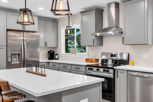 2627 Ramshorn Dr, Manasquan, NJ 08736 - kitchen with wall chimney exhaust hood, appliances with stainless steel finishes, gray cabinetry, a breakfast bar, and a center island