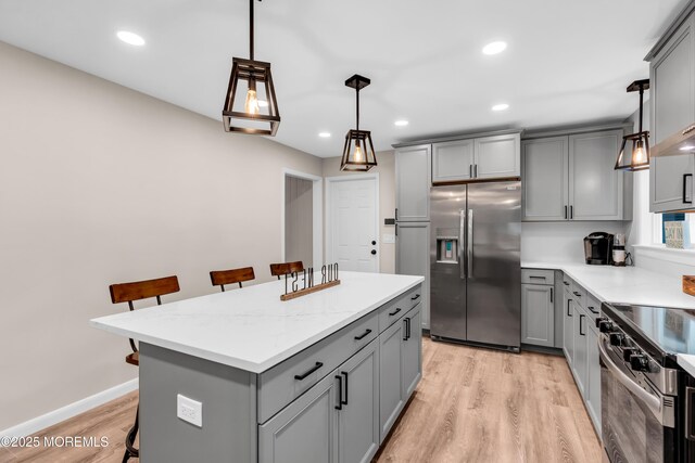 2627 Ramshorn Dr, Manasquan, NJ 08736 - kitchen featuring stainless steel appliances, gray cabinets, a breakfast bar area, light wood-type flooring, and recessed lighting