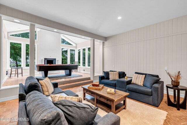 2627 Ramshorn Dr, Manasquan, NJ 08736 - living room featuring stone tile flooring, vaulted ceiling, a fireplace, and recessed lighting