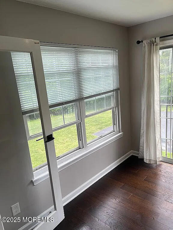 167 Frontier Way, Tinton Falls, NJ 07753 - spare room with healthy amount of natural light, dark wood-type flooring, and baseboards