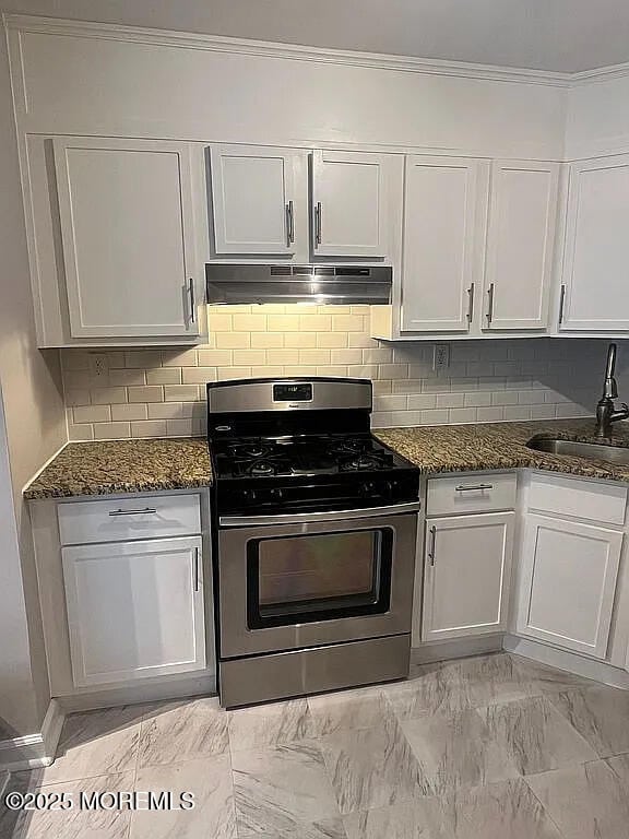 167 Frontier Way, Tinton Falls, NJ 07753 - kitchen featuring stainless steel gas stove, a sink, under cabinet range hood, dark stone counters, and white cabinets