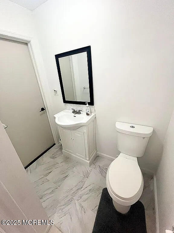 167 Frontier Way, Tinton Falls, NJ 07753 - half bath with vanity, toilet, and marble look tile flooring
