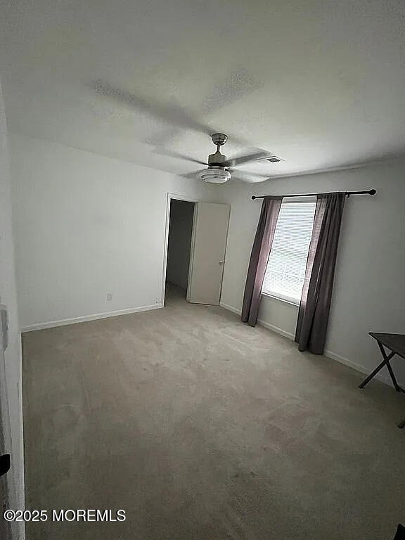 167 Frontier Way, Tinton Falls, NJ 07753 - spare room featuring ceiling fan, light carpet, and baseboards