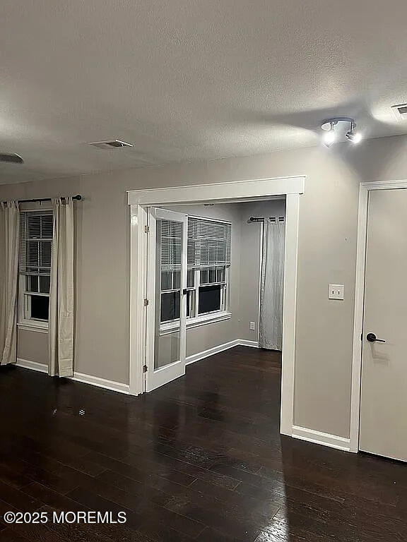 167 Frontier Way, Tinton Falls, NJ 07753 - unfurnished room featuring wood finished floors, baseboards, and a textured ceiling