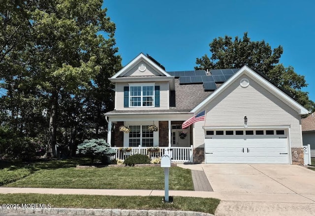 63 Briarwood Dr, Little Egg Harbor, NJ 08087 - traditional-style home featuring a porch, concrete driveway, a front lawn, solar panels, and a garage