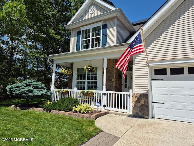 63 Briarwood Dr, Little Egg Harbor, NJ 08087 - view of front facade featuring a porch, stone siding, a garage, driveway, and a front lawn