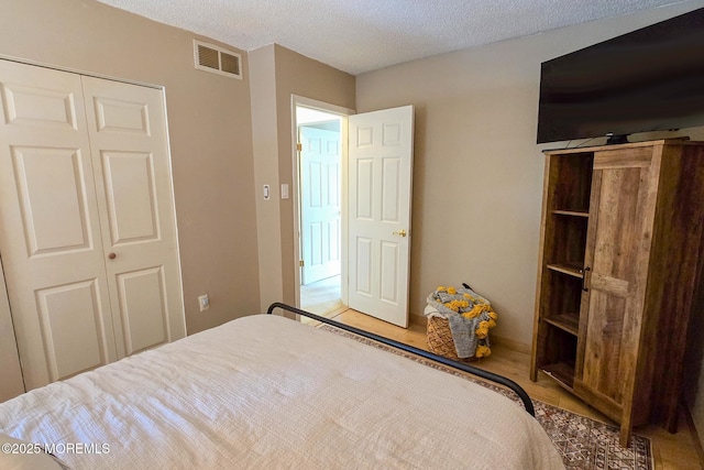 1 Lafayette Ct, Barnegat, NJ 08005 - bedroom with wood finished floors, a closet, and a textured ceiling