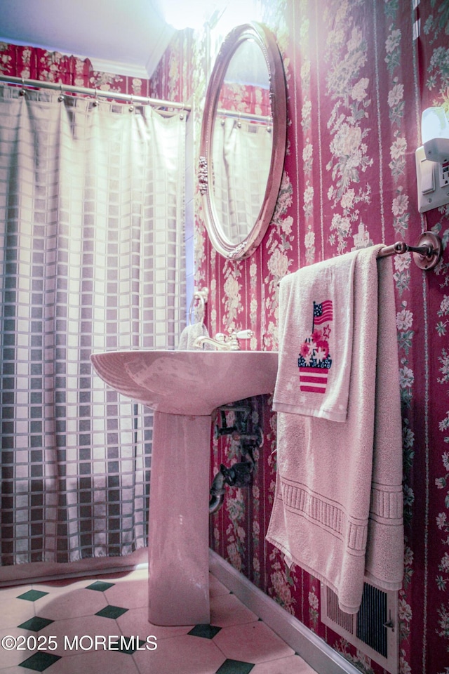 243 Main St, Port Monmouth, NJ 07758 - bathroom featuring wallpapered walls, crown molding, and tile patterned floors