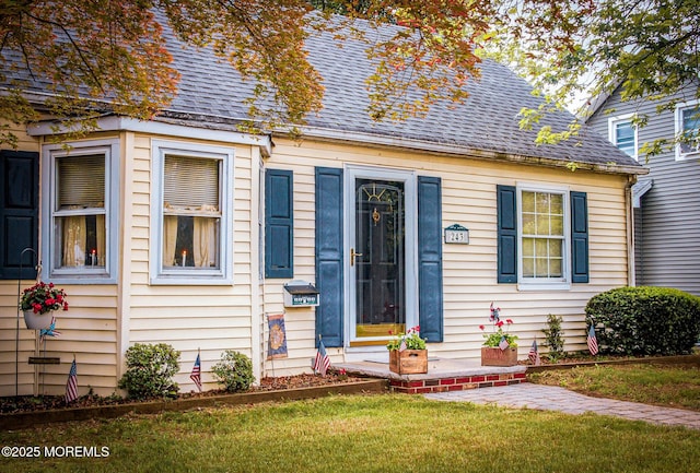 243 Main St, Port Monmouth, NJ 07758 - cape cod home featuring a shingled roof and a front yard