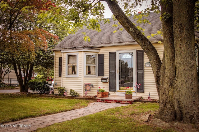 243 Main St, Port Monmouth, NJ 07758 - cape cod home featuring roof with shingles and a front yard