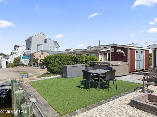 68 Gregg Dr, Beach Haven West, NJ 08050 - view of green lawn with a hot tub, a patio, and an outbuilding