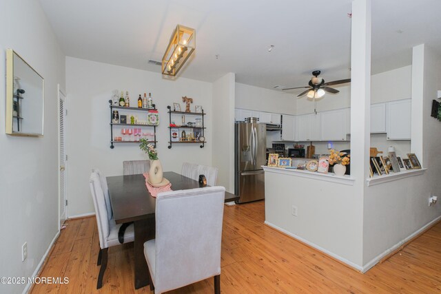 511 Coppola Dr, South Plainfield, NJ 07080 - dining space with light wood-style flooring, ceiling fan, and baseboards