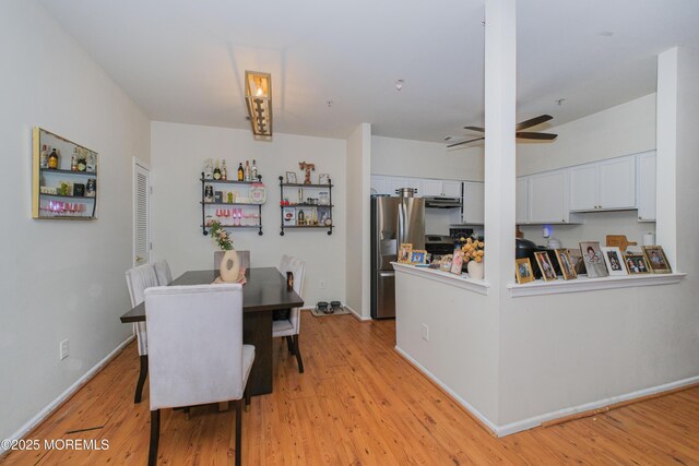 511 Coppola Dr, South Plainfield, NJ 07080 - dining area with light wood finished floors, ceiling fan, and baseboards