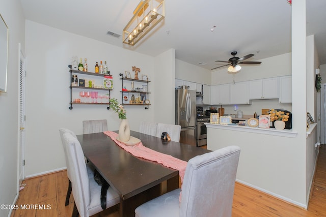 511 Coppola Dr, South Plainfield, NJ 07080 - dining room featuring light wood-style flooring, ceiling fan, and baseboards