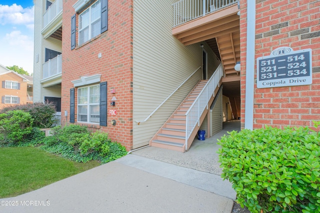511 Coppola Dr, South Plainfield, NJ 07080 - view of exterior entry with brick siding and a balcony