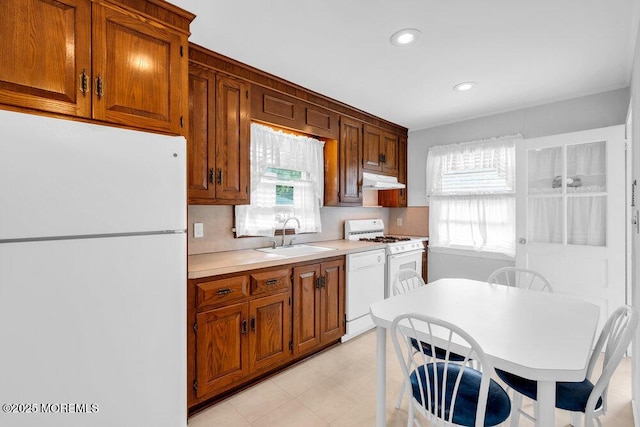 361 Meadowbrook Ave, Eatontown, NJ 07724 - kitchen with white appliances, a sink, under cabinet range hood, light countertops, and brown cabinetry
