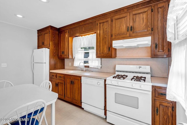 361 Meadowbrook Ave, Eatontown, NJ 07724 - kitchen with white appliances, under cabinet range hood, a sink, light countertops, and brown cabinetry