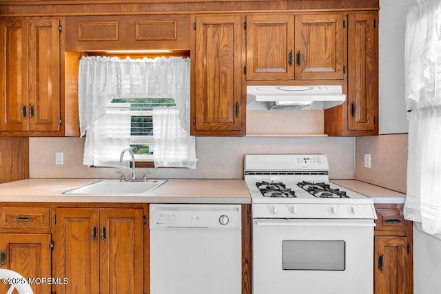 361 Meadowbrook Ave, Eatontown, NJ 07724 - kitchen featuring white appliances, under cabinet range hood, a sink, brown cabinets, and light countertops