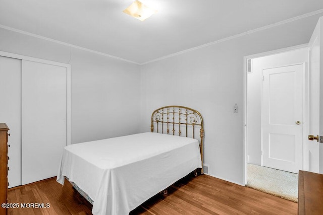 361 Meadowbrook Ave, Eatontown, NJ 07724 - bedroom with crown molding, wood finished floors, and a closet