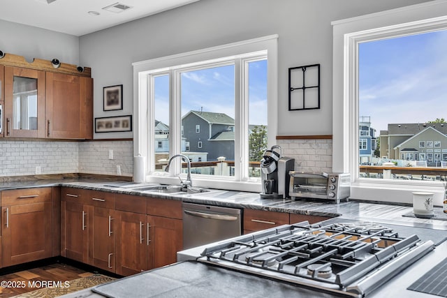1639 Bay Blvd, Ortley Beach, NJ 08751 - kitchen featuring dishwasher, tasteful backsplash, glass insert cabinets, dark wood-style floors, and brown cabinets