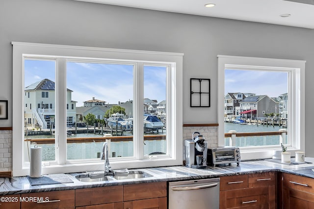 1639 Bay Blvd, Ortley Beach, NJ 08751 - kitchen featuring stainless steel dishwasher, a water view, a residential view, and dark stone counters