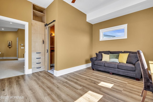 1639 Bay Blvd, Ortley Beach, NJ 08751 - living area with a barn door, wood finished floors, and ceiling fan