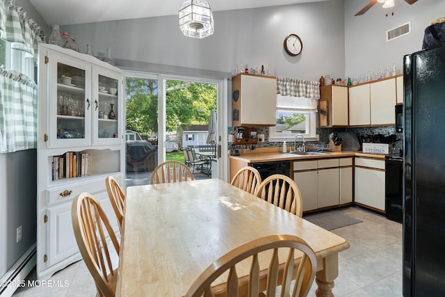 33 Oak Ln, Little Egg Harbor, NJ 08087 - kitchen featuring baseboard heating, high vaulted ceiling, black appliances, a sink, and light tile patterned floors