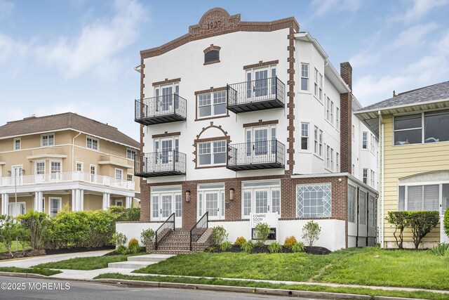205 Edgemont Dr Unit 2, Loch Arbour Village, NJ 07711 - view of property with stucco siding, french doors, and brick siding