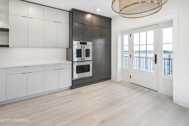 205 Edgemont Dr Unit 2, Loch Arbour Village, NJ 07711 - kitchen featuring double oven, modern cabinets, light countertops, light wood-style flooring, and recessed lighting