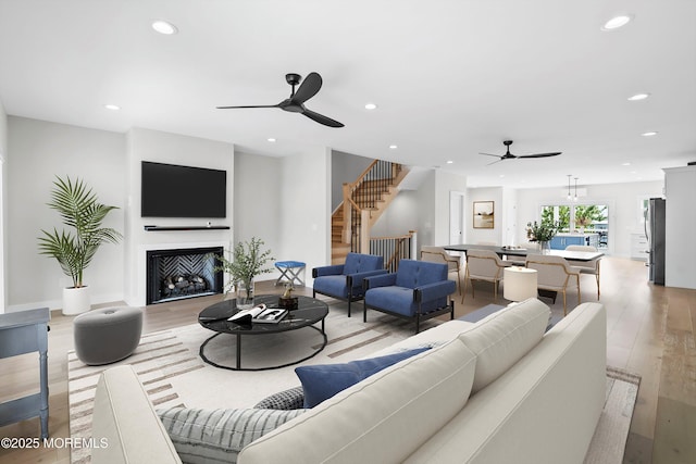 72 4th St, Highlands, NJ 07732 - living room featuring a ceiling fan, recessed lighting, light wood-type flooring, a fireplace, and stairway