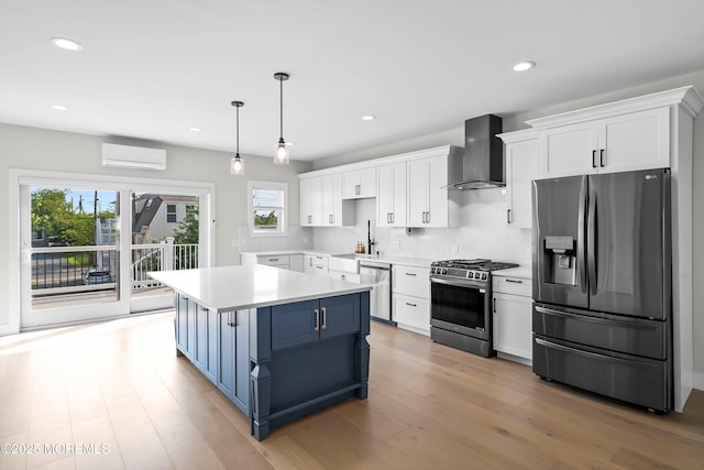 72 4th St, Highlands, NJ 07732 - kitchen with appliances with stainless steel finishes, wall chimney range hood, a wall mounted AC, a sink, and white cabinets