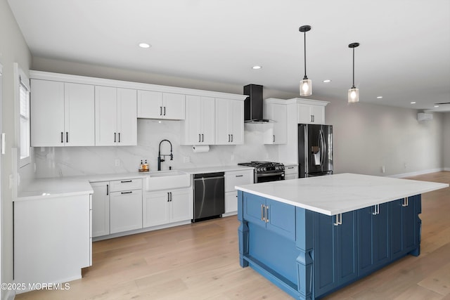 72 4th St, Highlands, NJ 07732 - kitchen with blue cabinetry, appliances with stainless steel finishes, wall chimney exhaust hood, light wood-type flooring, and a sink