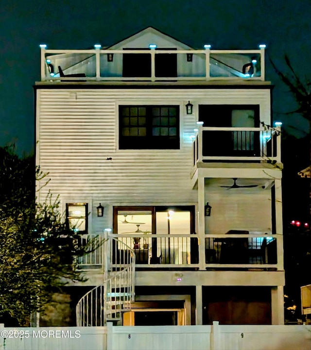 72 4th St, Highlands, NJ 07732 - back of house at night featuring a balcony