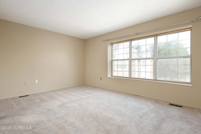 62 Cohasset Ct, Holmdel, NJ 07733 - carpeted empty room with a textured ceiling and baseboards
