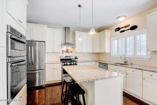 10 Unity Ct, Middletown, NJ 07748 - kitchen featuring wall chimney exhaust hood, appliances with stainless steel finishes, a sink, dark wood-style floors, and a center island