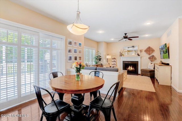 10 Unity Ct, Middletown, NJ 07748 - dining room with dark wood-style floors, a ceiling fan, a warm lit fireplace, recessed lighting, and baseboards