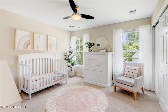 10 Unity Ct, Middletown, NJ 07748 - carpeted bedroom with a closet, a nursery area, a ceiling fan, and baseboards