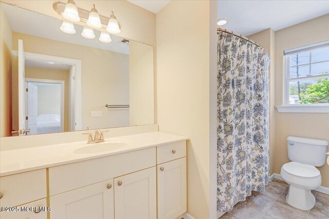 10 Unity Ct, Middletown, NJ 07748 - full bath with vanity, toilet, baseboards, a shower with shower curtain, and ensuite bath