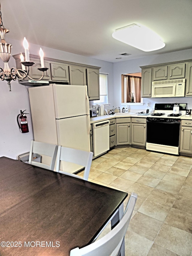 12 Skylark Ln, Lakewood, NJ 08701 - kitchen with white appliances, light countertops, a sink, gray cabinetry, and a chandelier