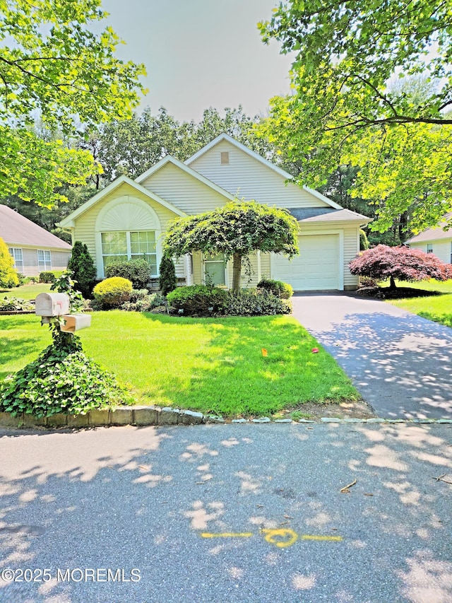 12 Skylark Ln, Lakewood, NJ 08701 - view of front of home with asphalt driveway, a front yard, and an attached garage