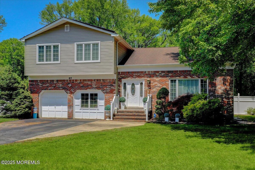 97 Lafayette Mills Rd, Manalapan, NJ 07726 - view of front of home featuring asphalt driveway, a garage, and brick siding