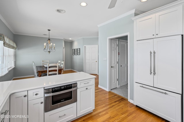 7 Brown Ave, Lavallette, NJ 08735 - kitchen featuring recessed lighting, white cabinetry, crown molding, light countertops, and a chandelier