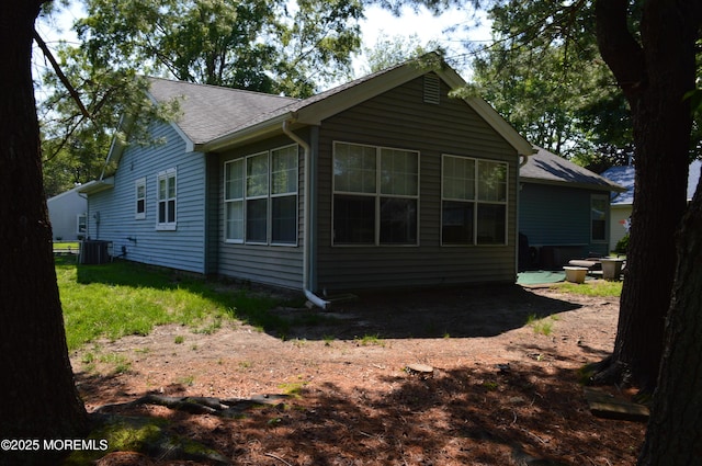 38 Sheffield Dr, Forked River, NJ 08731 - view of side of home with a central AC unit and a shingled roof