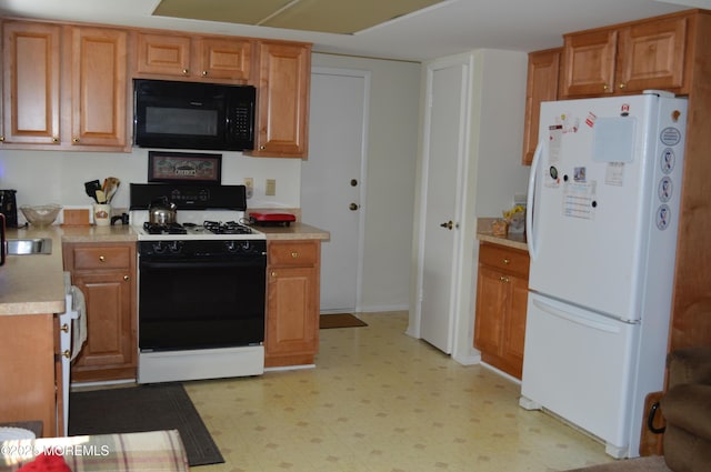38 Sheffield Dr, Forked River, NJ 08731 - kitchen with black microwave, freestanding refrigerator, stove, light floors, and light countertops