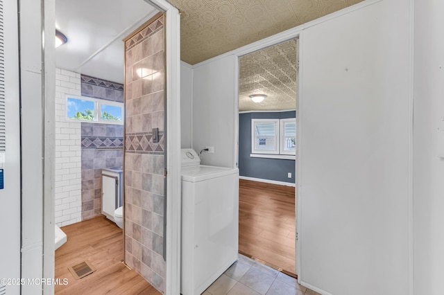 23 Southwind Cir, Jackson, NJ 08527 - bathroom with washer / dryer, wood finished floors, baseboards, and tile walls
