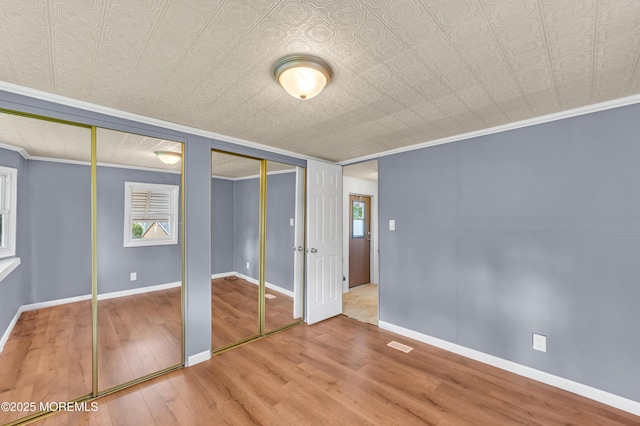 23 Southwind Cir, Jackson, NJ 08527 - unfurnished bedroom featuring multiple closets, ornamental molding, wood finished floors, baseboards, and an ornate ceiling
