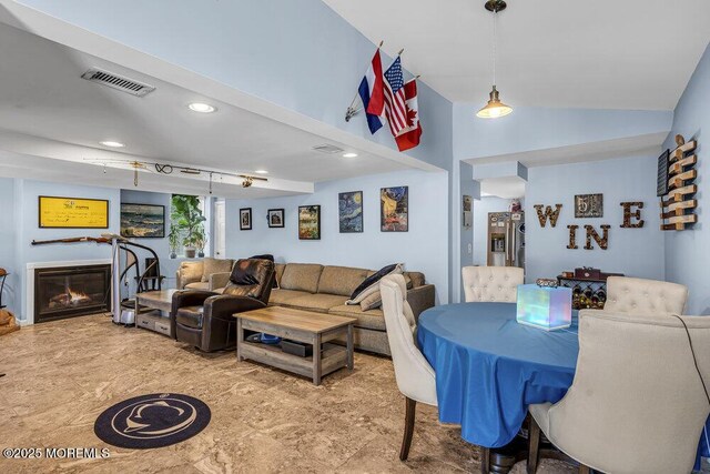 1208 Pine Tree Way, Belmar, NJ 07719 - living room with vaulted ceiling, a glass covered fireplace, and recessed lighting
