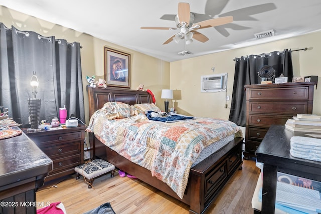 1920 W Lake Ave, Neptune Township, NJ 07753 - bedroom with an AC wall unit, light wood-style flooring, and ceiling fan